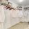 a room with a white wall with a white curtain and a basket