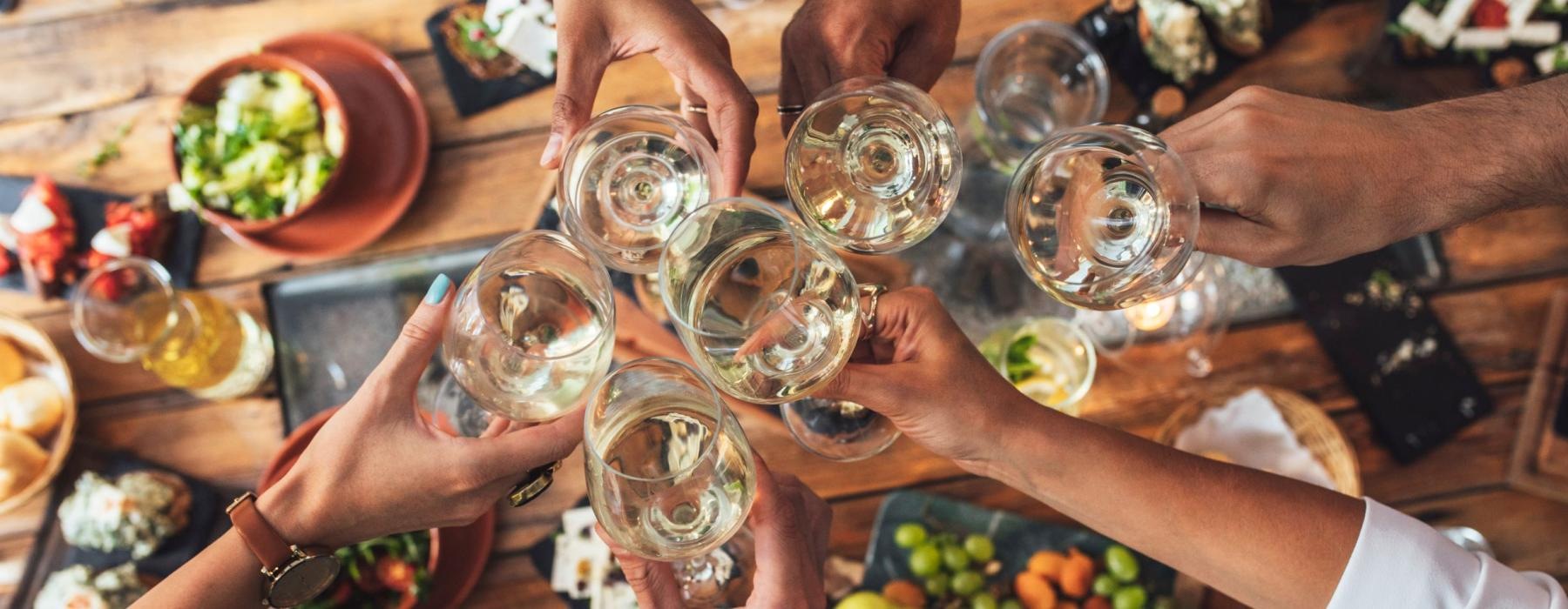 a group of people holding wine glasses