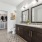 a bathroom with a double vanity and  two large mirrors 