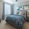 a bedroom with a bed and a fan