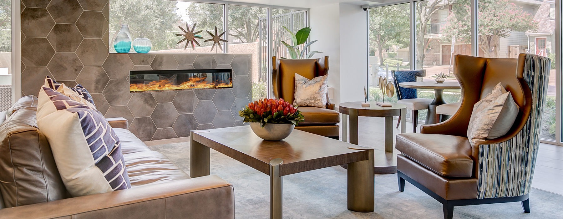 room with chairs, coffee table, fireplace and large window